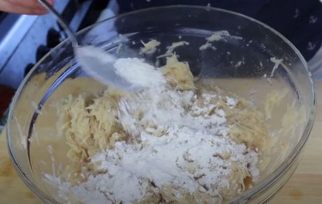 add flour to grated potatoes